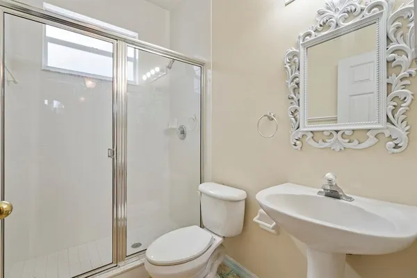 a bathroom with a sink toilet and shower