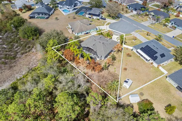 an aerial view of a house with a mountain