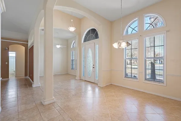 a view of an empty room with a fireplace and a window