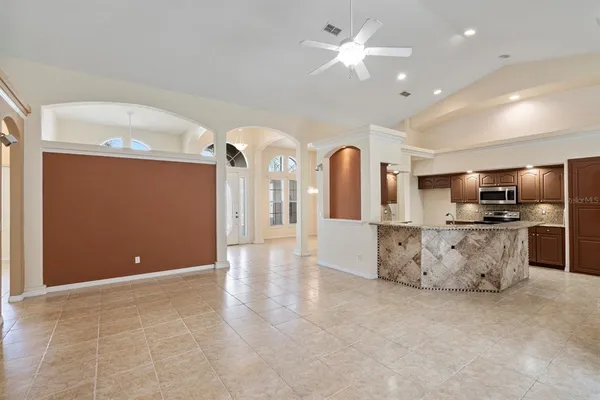 a view of kitchen with stainless steel appliances kitchen island refrigerator stove and microwave