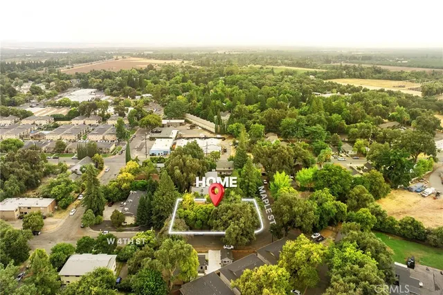 an aerial view of residential building with outdoor space and trees