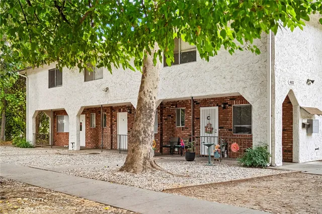 a front view of a house with garden and plants