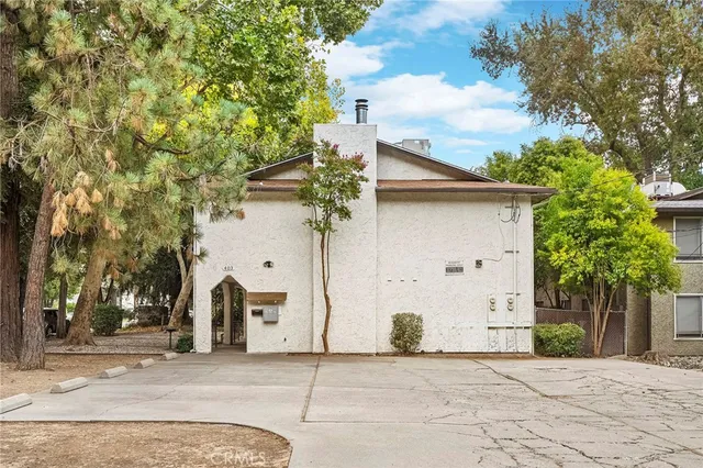 a front view of a house with plants