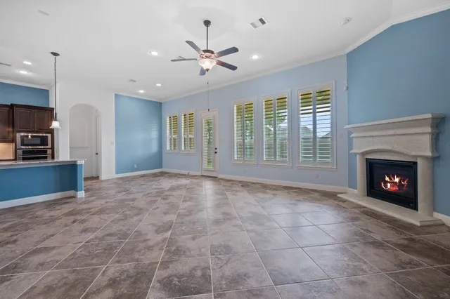 a view of an empty room with a fireplace and a window