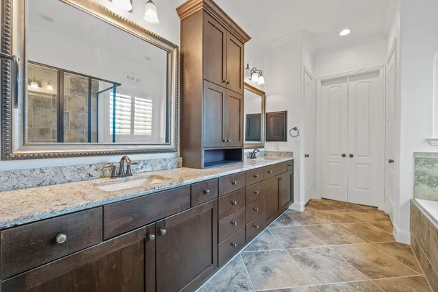 a spacious bathroom with a granite countertop sink mirror and double