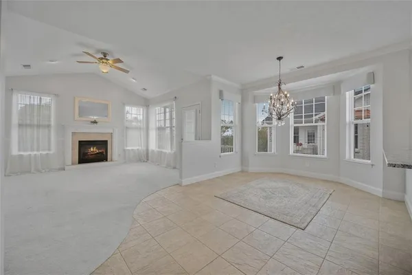 a view of empty room with window and fireplace