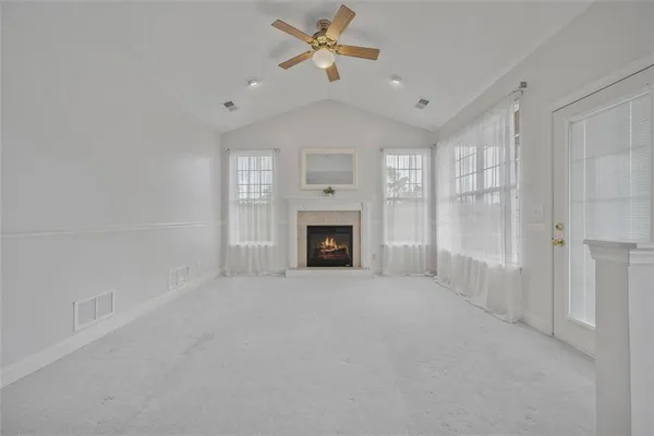 a view of empty room with wooden floor and window