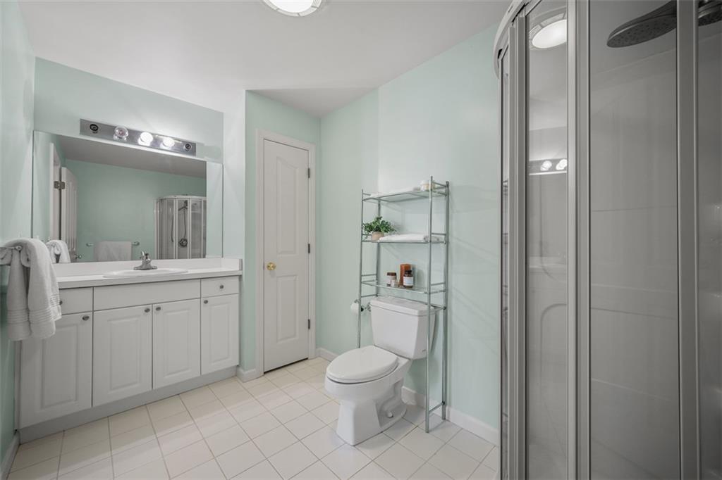 246 Adams Pointe Boulevard, Unit 1 Mars, PA 16046 - Photo 24 of 37 a bathroom with a toilet a sink and mirror