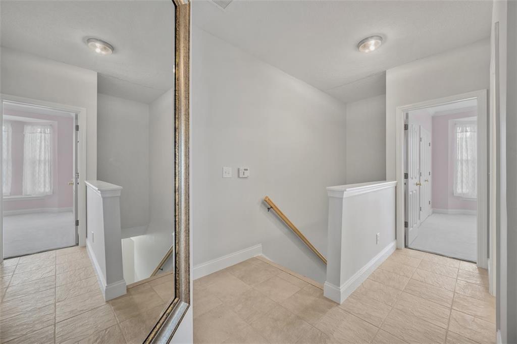 246 Adams Pointe Boulevard, Unit 1 Mars, PA 16046 - Photo 25 of 37 a view of a hallway with white walls and stairs