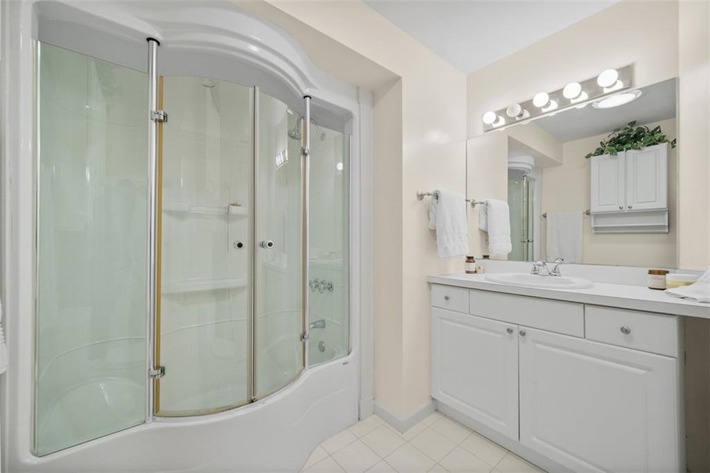 246 Adams Pointe Boulevard, Unit 1 Mars, PA 16046 - Photo 28 of 37 a bathroom with a double vanity sink mirror and shower