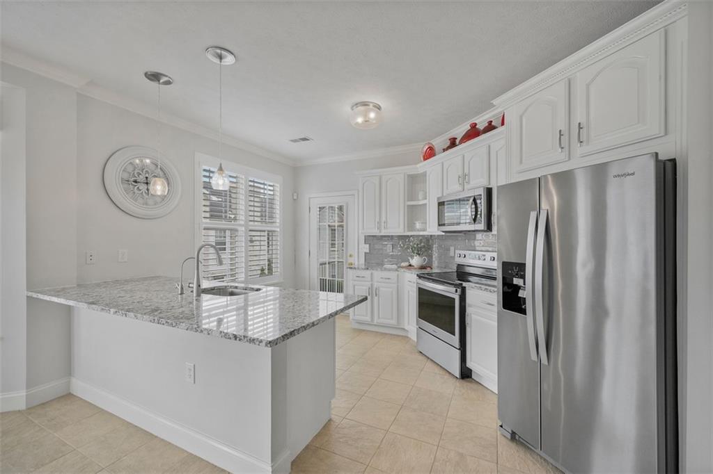 246 Adams Pointe Boulevard, Unit 1 Mars, PA 16046 - Photo 8 of 37 a kitchen with stainless steel appliances granite countertop a refrigerator sink and stove