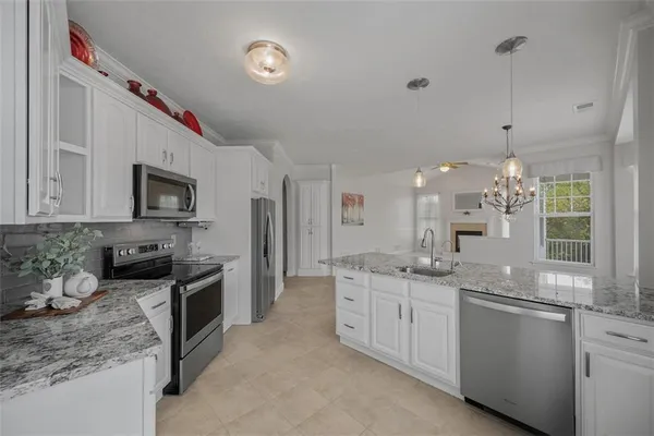 a bathroom with a granite countertop sink and a large mirror