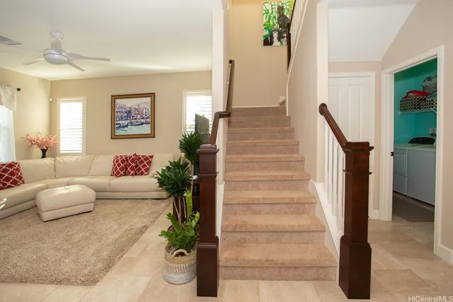 a living room with furniture and a potted plant
