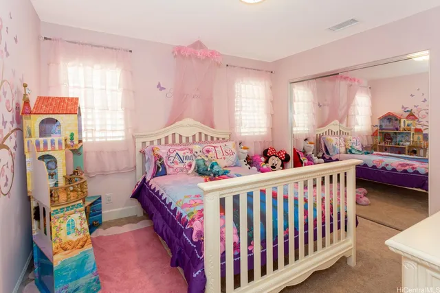 a bedroom with furniture and a large window