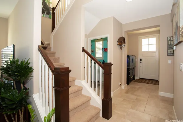 a view of an entryway with wooden floor and stairs