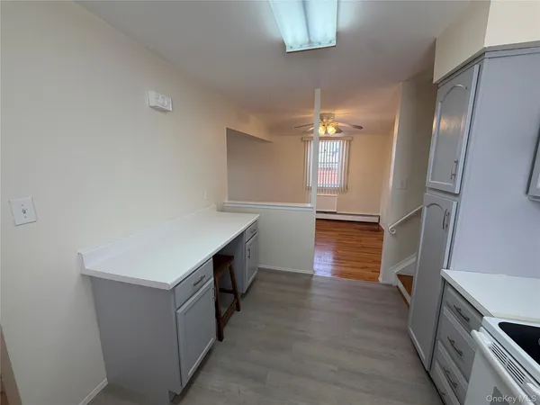 a hallway view with wooden floor and staircase