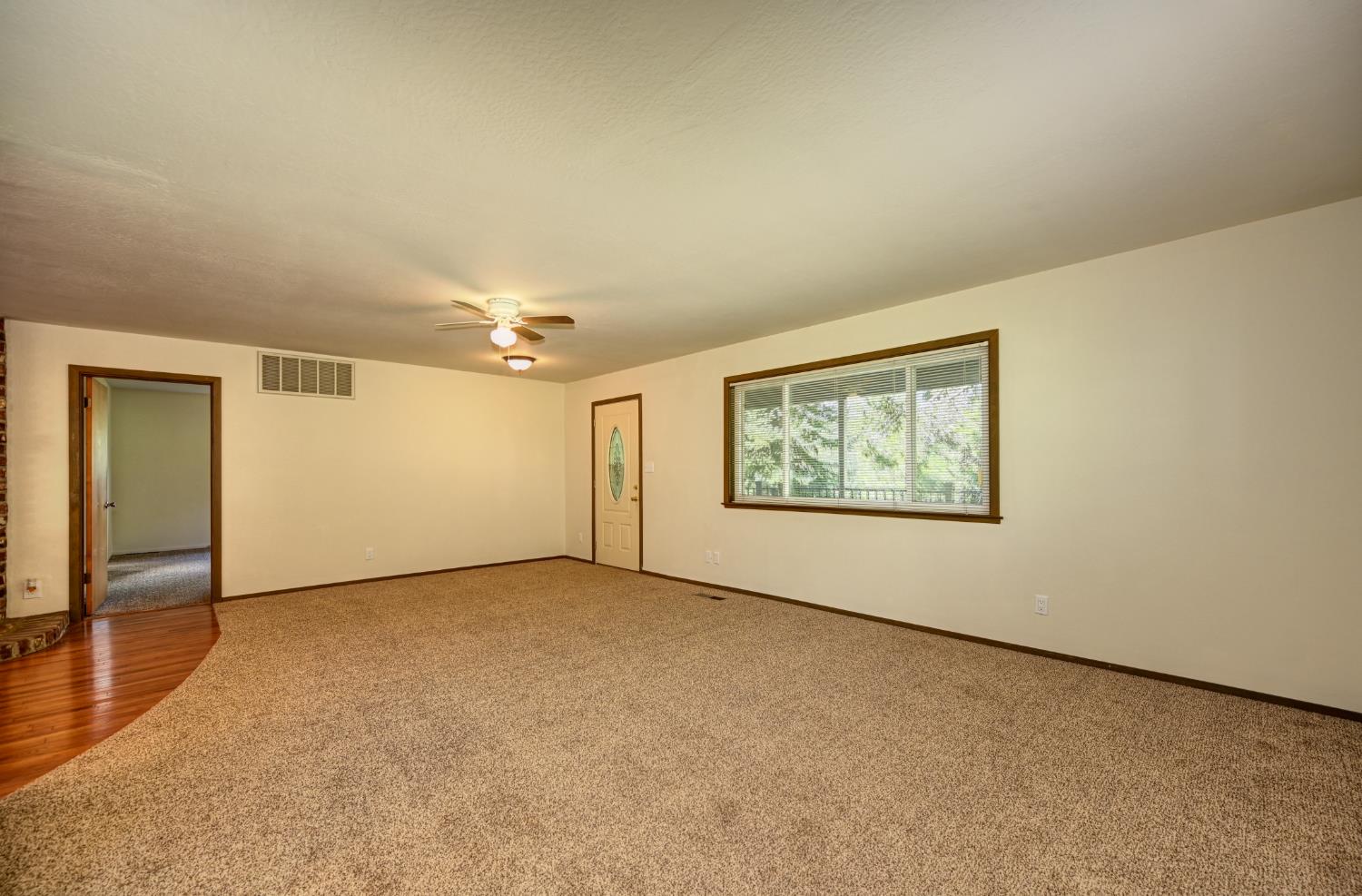 4541 Meadowbrook Road Garden Valley, CA 95633 - Photo 24 of 71 carpeted spare room featuring a ceiling fan and baseboards