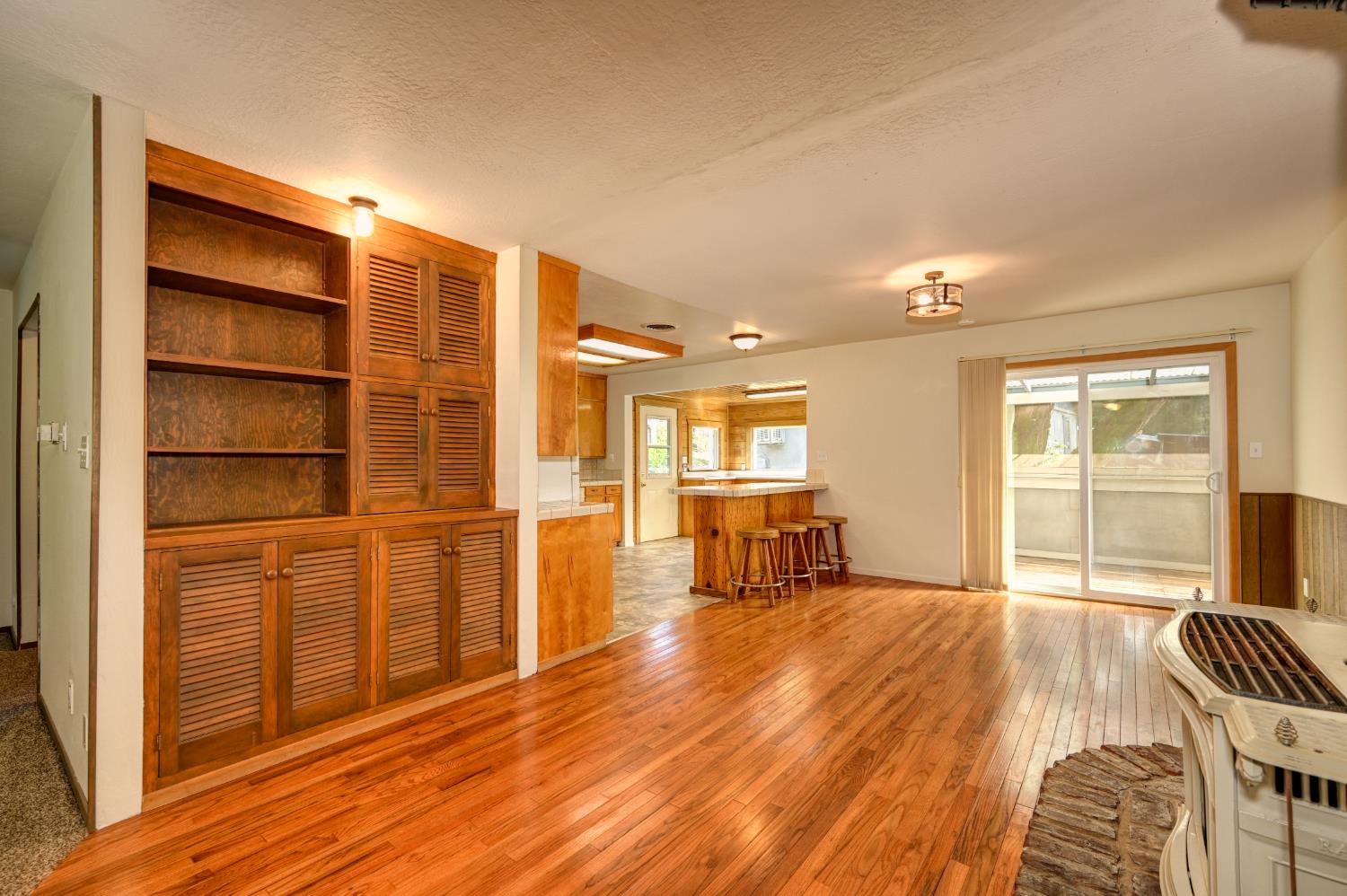 4541 Meadowbrook Road Garden Valley, CA 95633 - Photo 28 of 71 living room with plenty of natural light, light wood finished floors, and a textured ceiling