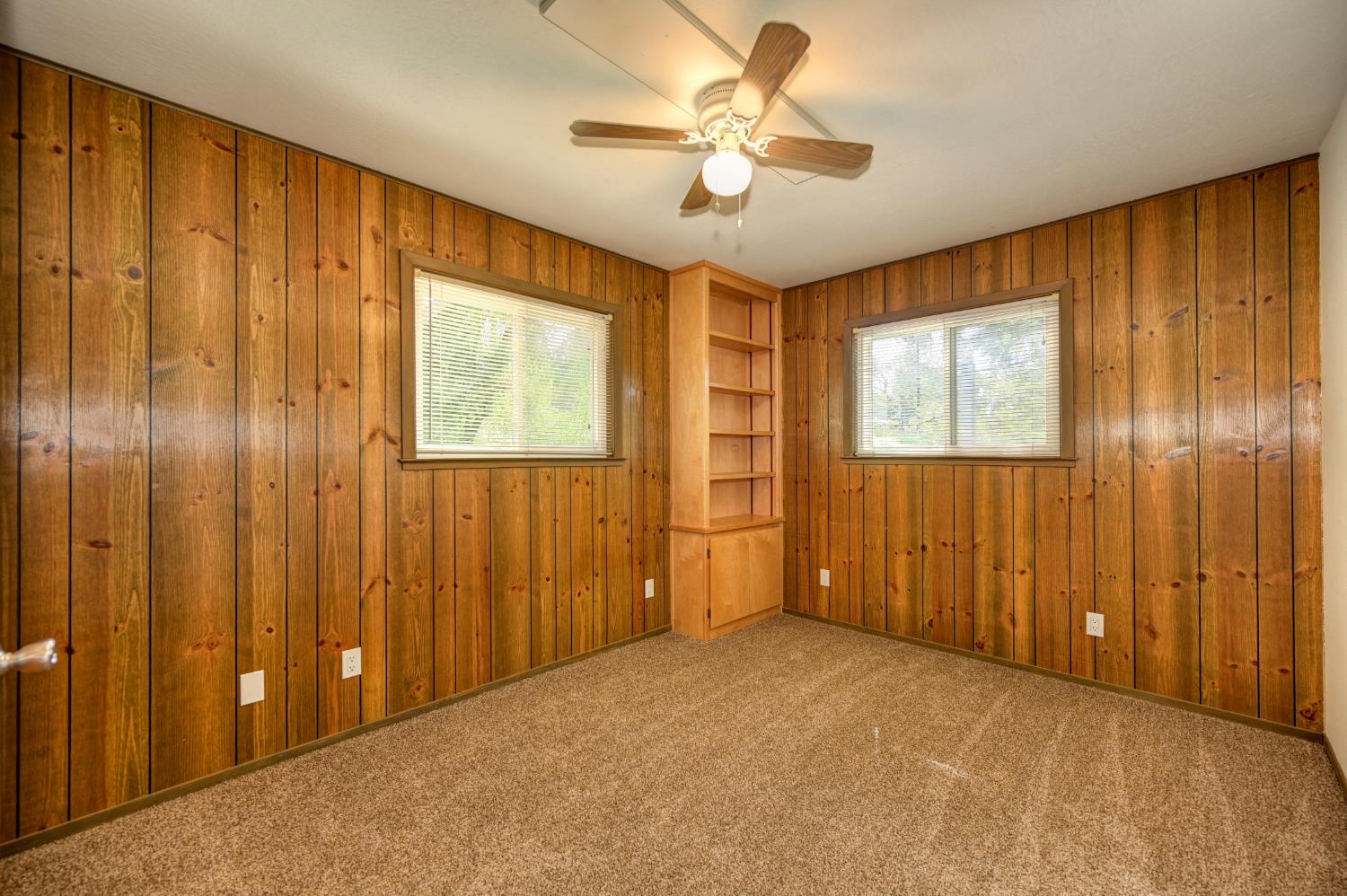 4541 Meadowbrook Road Garden Valley, CA 95633 - Photo 41 of 71 unfurnished room with wooden walls, carpet flooring, ceiling fan, and plenty of natural light