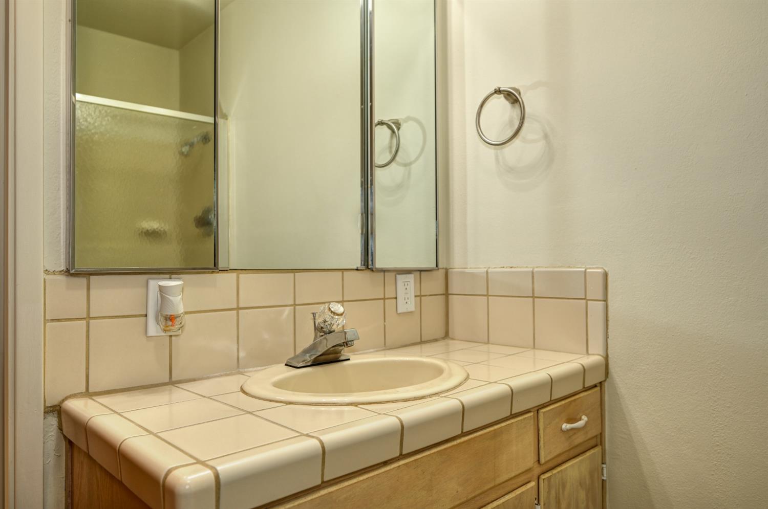 4541 Meadowbrook Road Garden Valley, CA 95633 - Photo 45 of 71 full bathroom featuring vanity, backsplash, a stall shower, and a textured wall