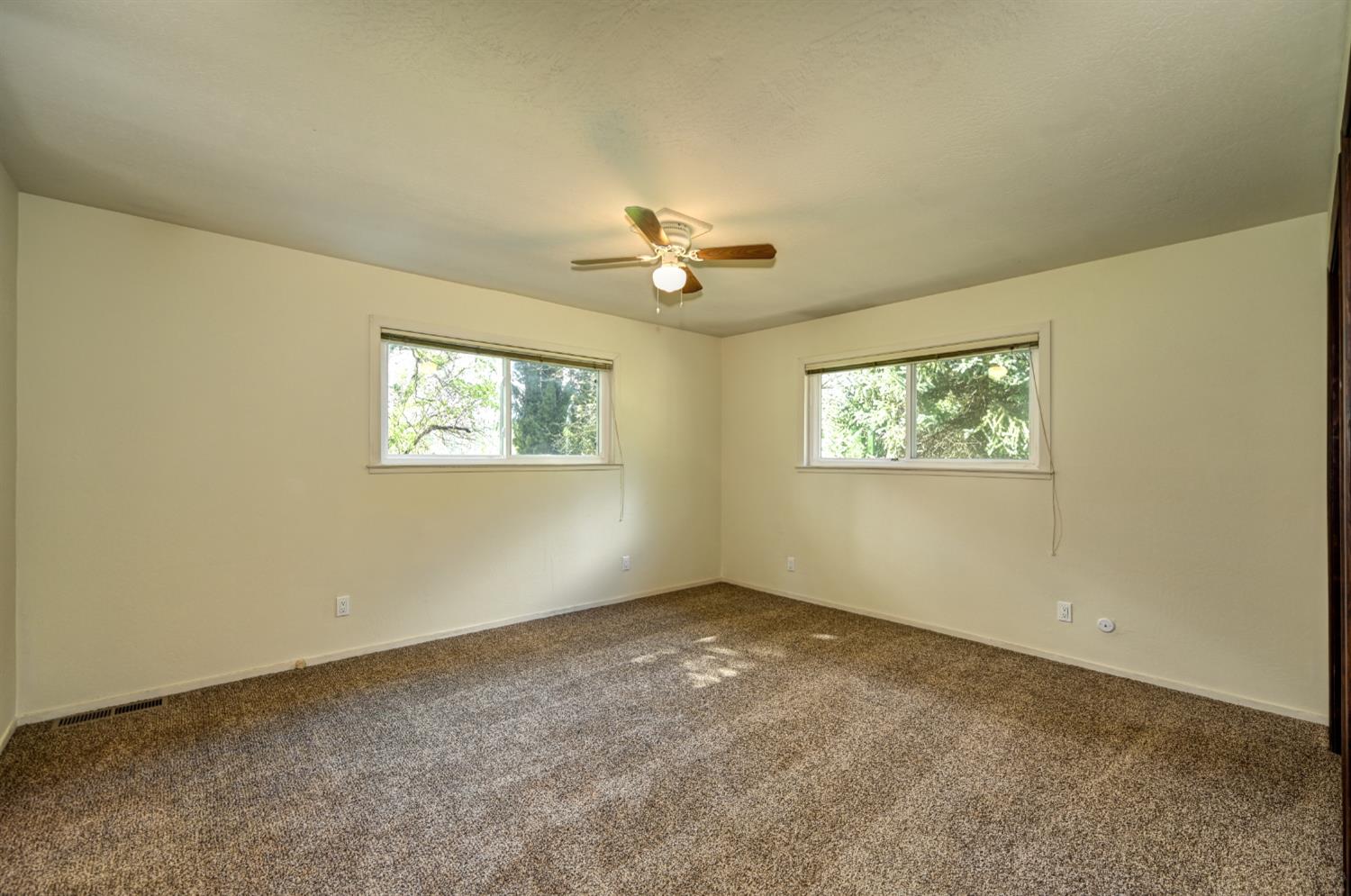 4541 Meadowbrook Road Garden Valley, CA 95633 - Photo 47 of 71 empty room with dark carpet and ceiling fan