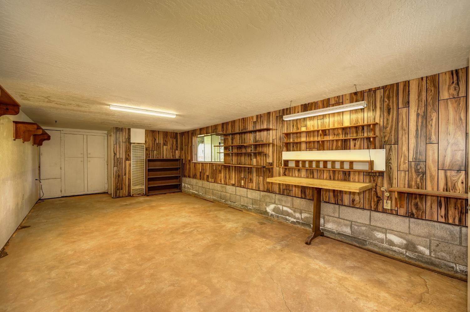 4541 Meadowbrook Road Garden Valley, CA 95633 - Photo 57 of 71 basement featuring wooden walls and a textured ceiling