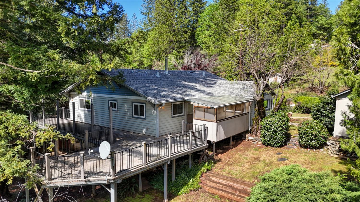 4541 Meadowbrook Road Garden Valley, CA 95633 - Photo 6 of 71 back of property featuring a wooden deck, roof with shingles, a sunroom, and view of scattered trees