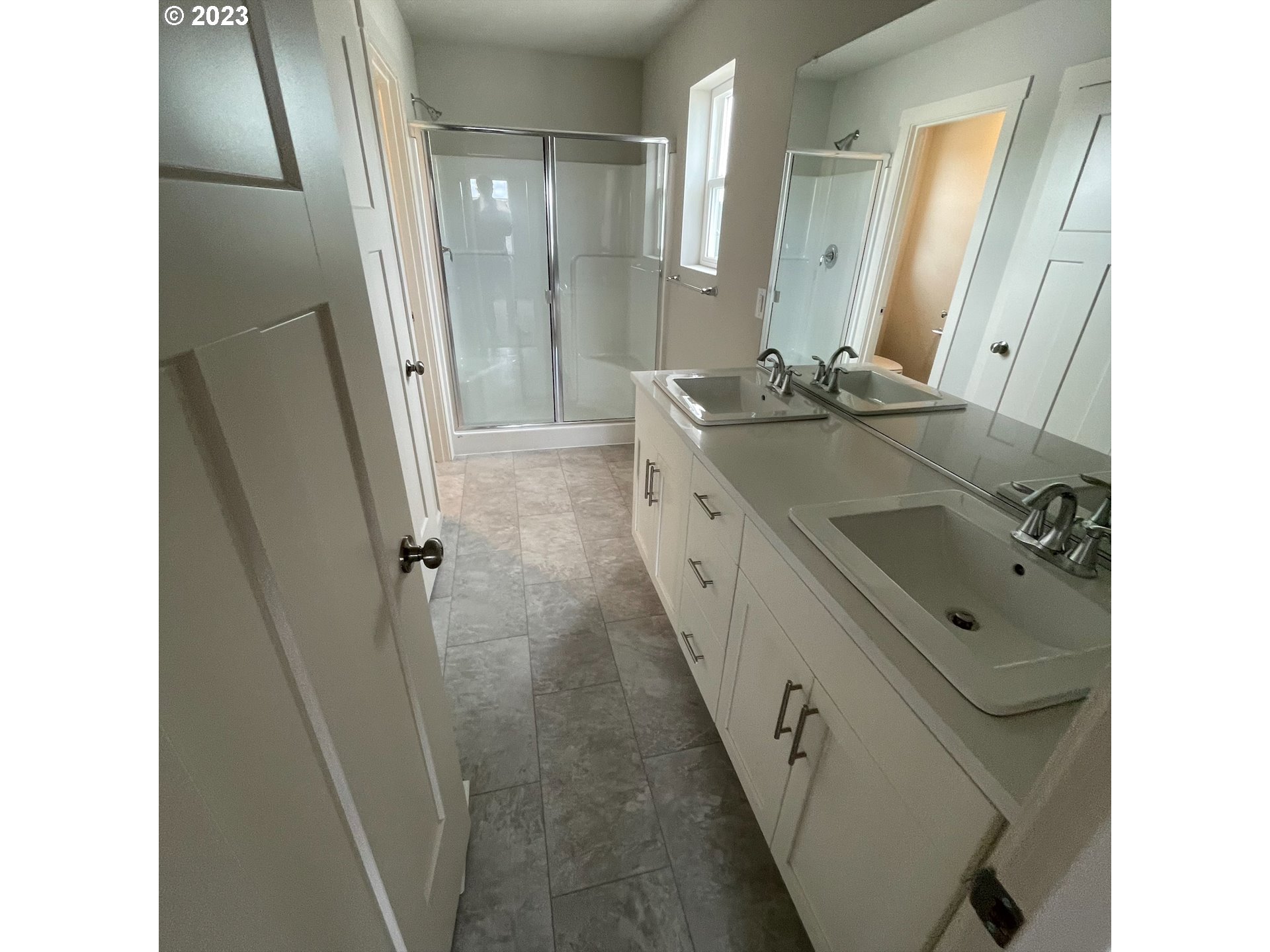 2083 Southeast Pheasant Avenue Gresham, OR 97080 - Photo 18 of 30 a bathroom with a double vanity sink a mirror and a shower