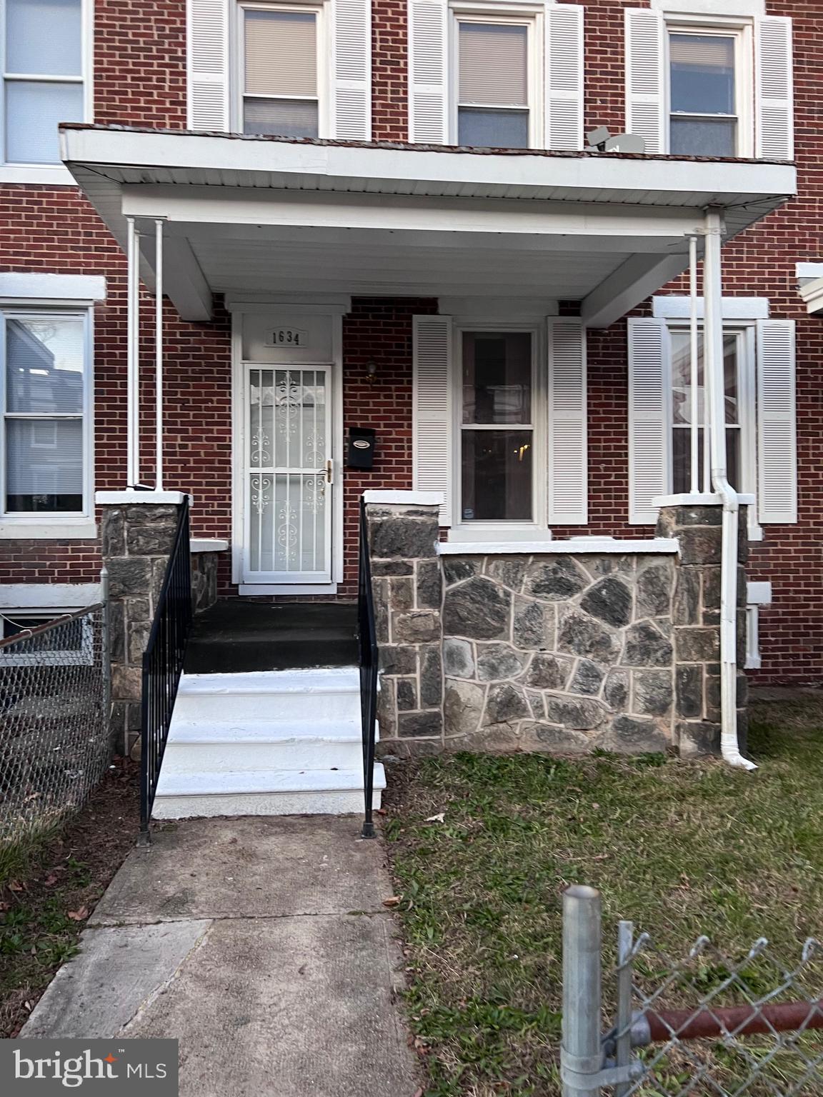 1634 Chilton Street Baltimore, MD 21218 - Photo 1 of 18 front view of a house with a yard