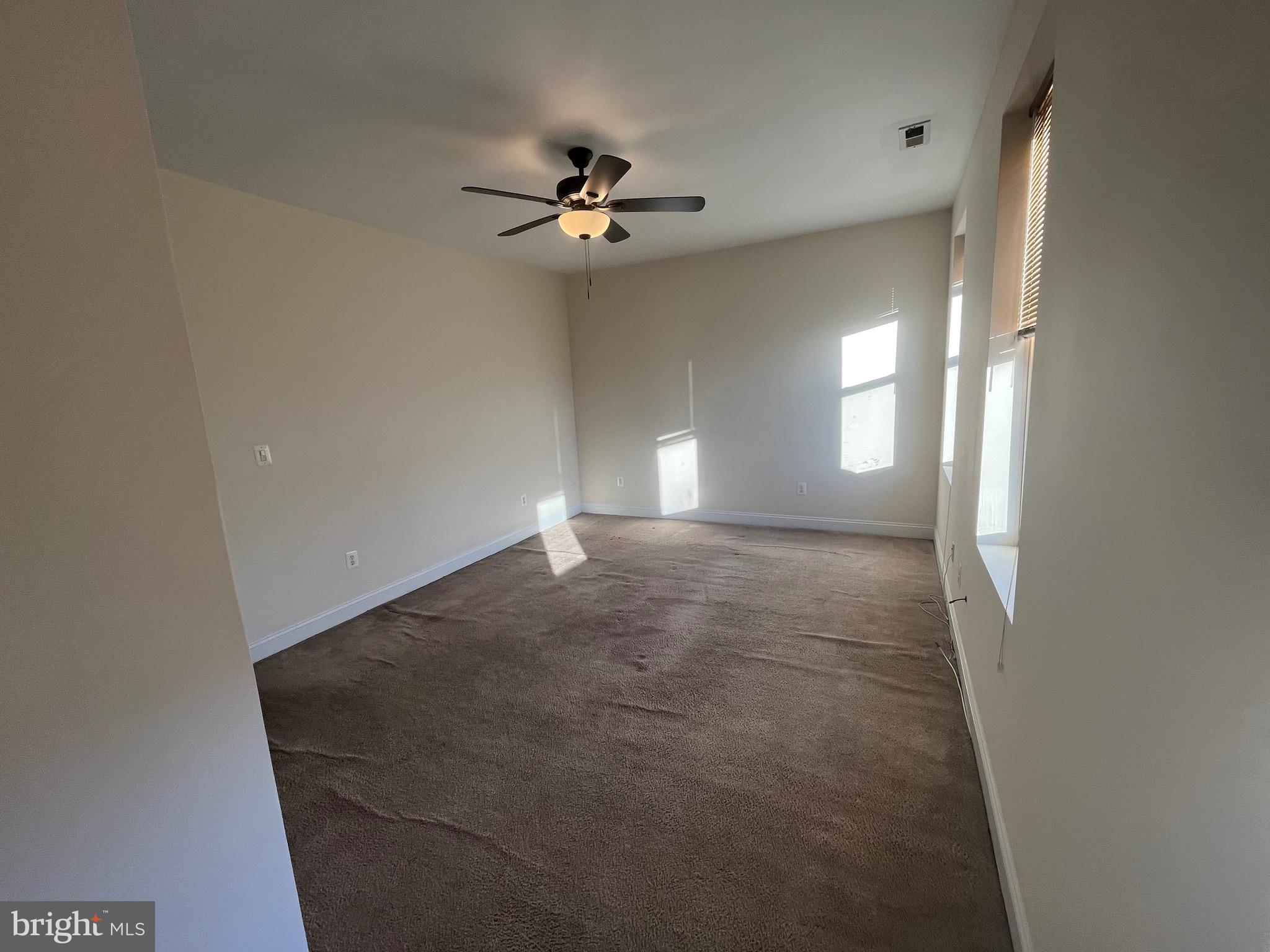 1634 Chilton Street Baltimore, MD 21218 - Photo 11 of 18 a view of empty room with window and chandelier fan