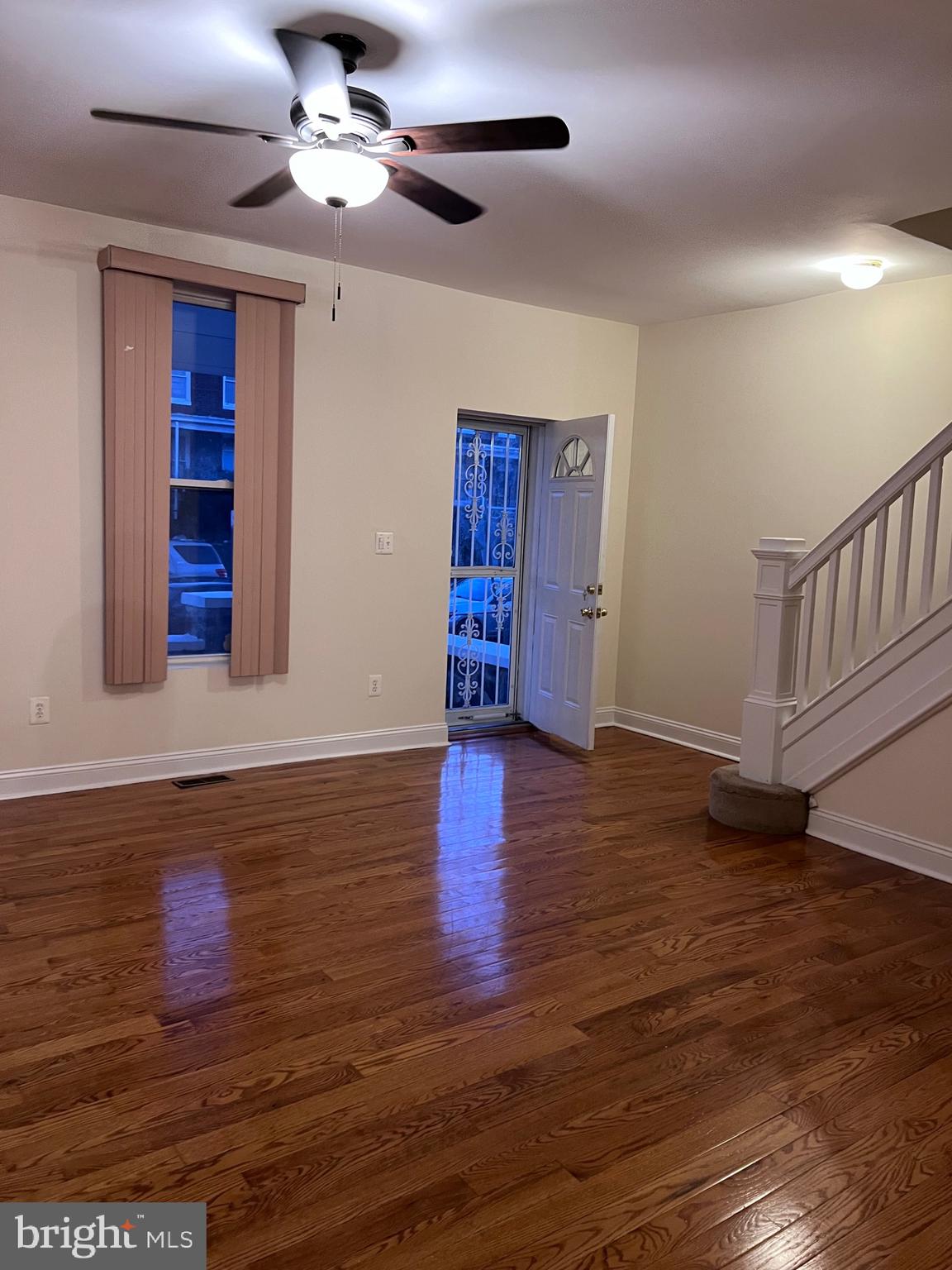 1634 Chilton Street Baltimore, MD 21218 - Photo 2 of 18 a view of an empty room with wooden floor ceiling fan