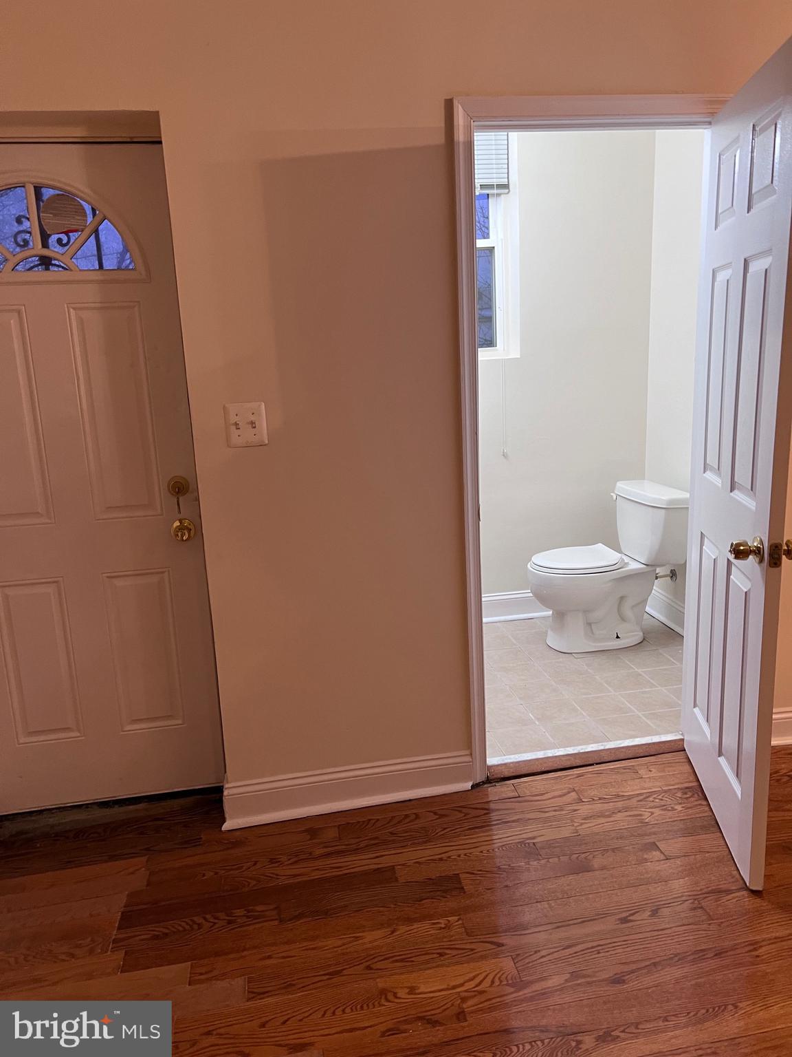 1634 Chilton Street Baltimore, MD 21218 - Photo 5 of 18 a view of a hallway with wooden floor and a cabinet