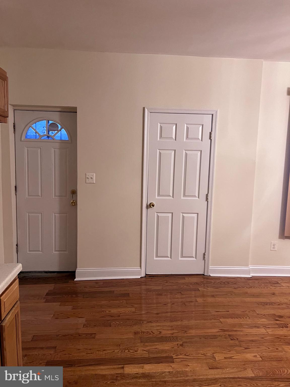 1634 Chilton Street Baltimore, MD 21218 - Photo 7 of 18 a view of empty room with wooden floor and fan