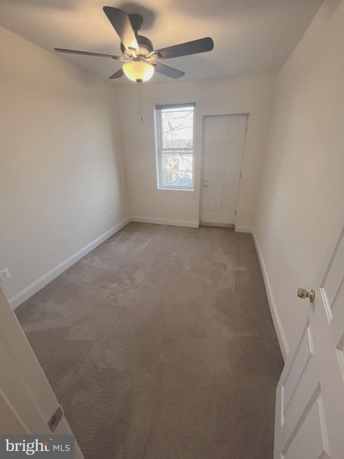1634 Chilton Street Baltimore, MD 21218 - Photo 9 of 18 an empty room with windows and fan