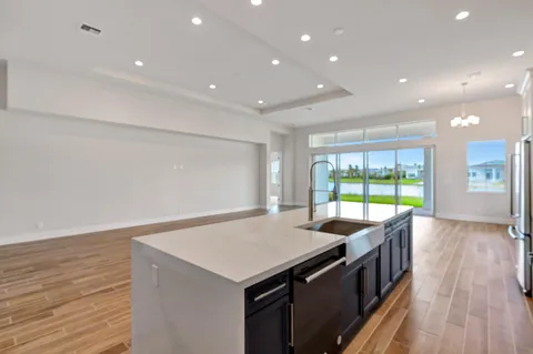 a spacious bathroom with a granite countertop tub sink a mirror a shower and vanity