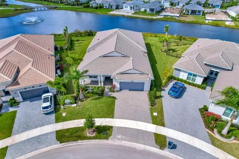 an aerial view of a house with garden space and a car park