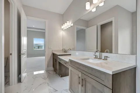 a bathroom with a double vanity sink and mirror