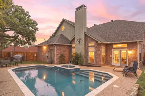 a view of a house with swimming pool and sitting area