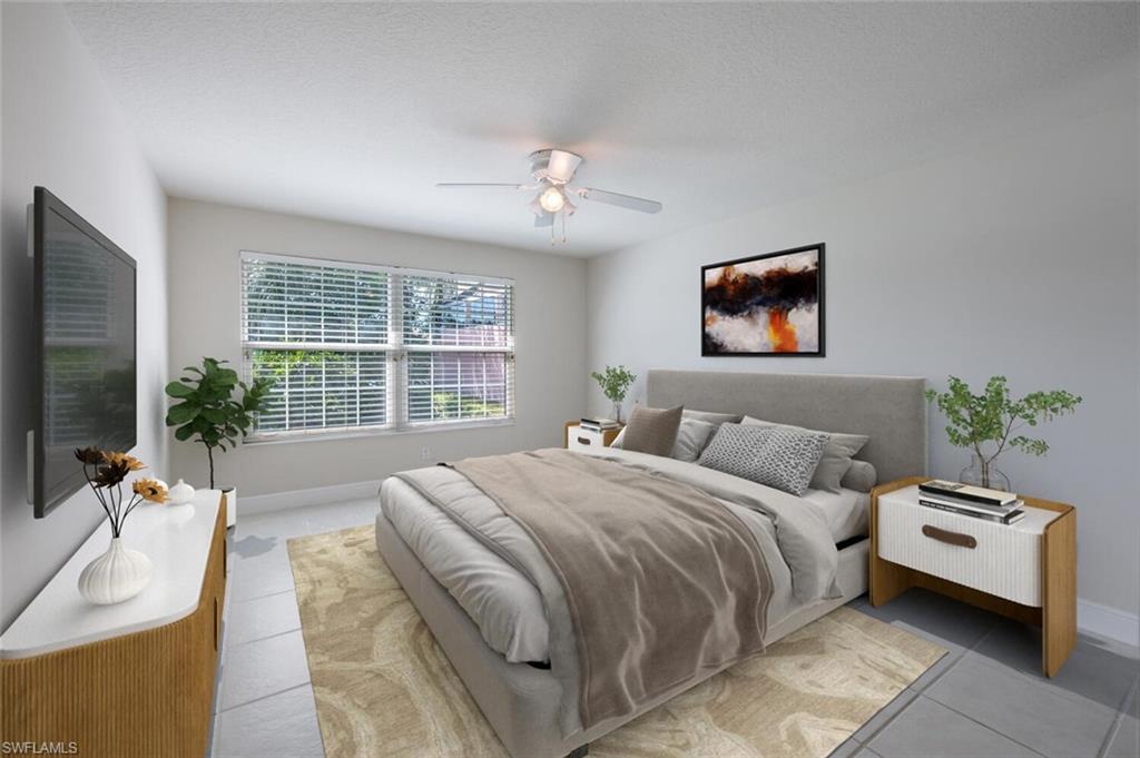 4231 Redonda Lane Naples, FL 34119 - Photo 11 of 28 a bedroom with a balcony a bed and a flat screen tv