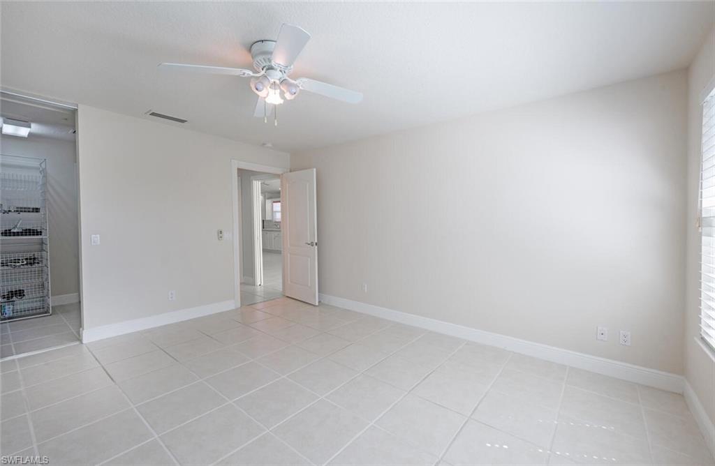 4231 Redonda Lane Naples, FL 34119 - Photo 14 of 28 wooden floor in an empty room