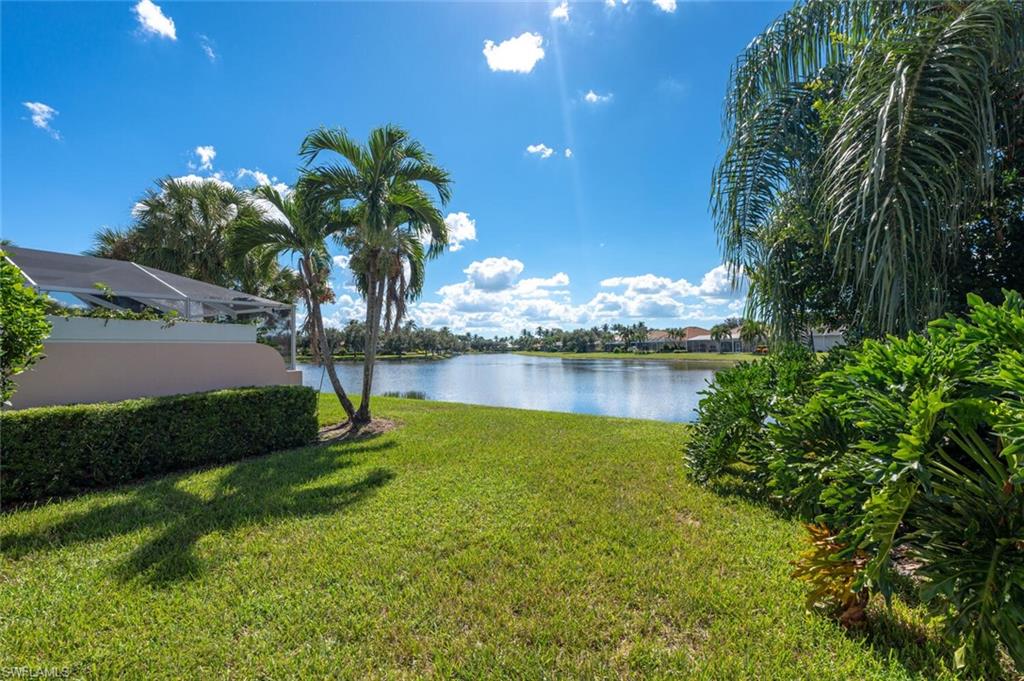 4231 Redonda Lane Naples, FL 34119 - Photo 19 of 28 a view of a lake with a garden