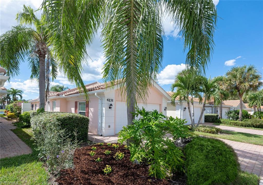 4231 Redonda Lane Naples, FL 34119 - Photo 2 of 28 a front view of house with yard and green space