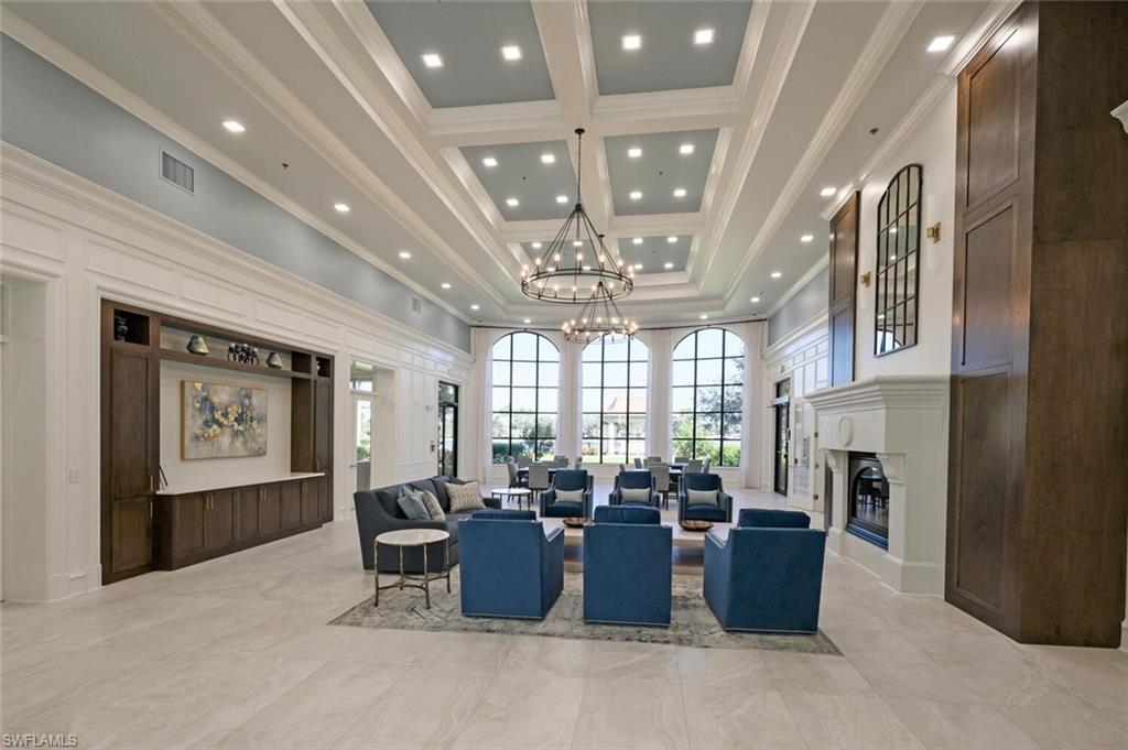 4231 Redonda Lane Naples, FL 34119 - Photo 22 of 28 a view of a dining room with furniture a chandelier and window