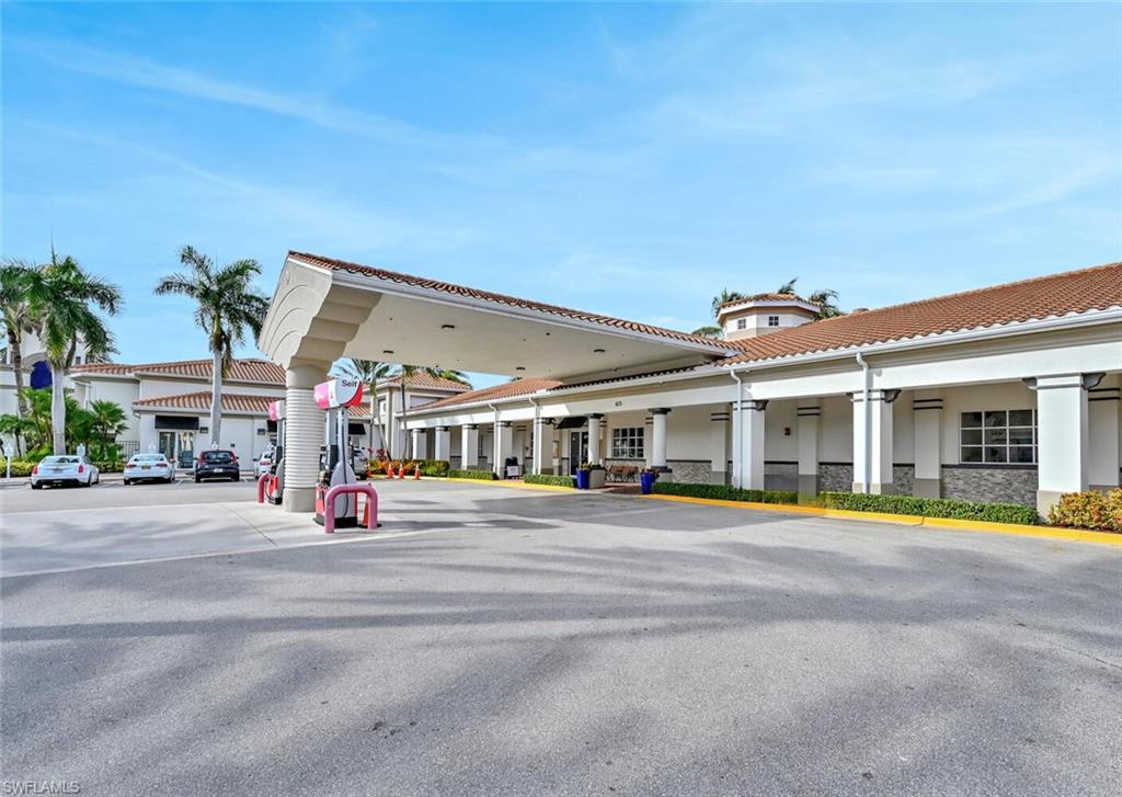 4231 Redonda Lane Naples, FL 34119 - Photo 24 of 28 a view of a building with a swimming pool