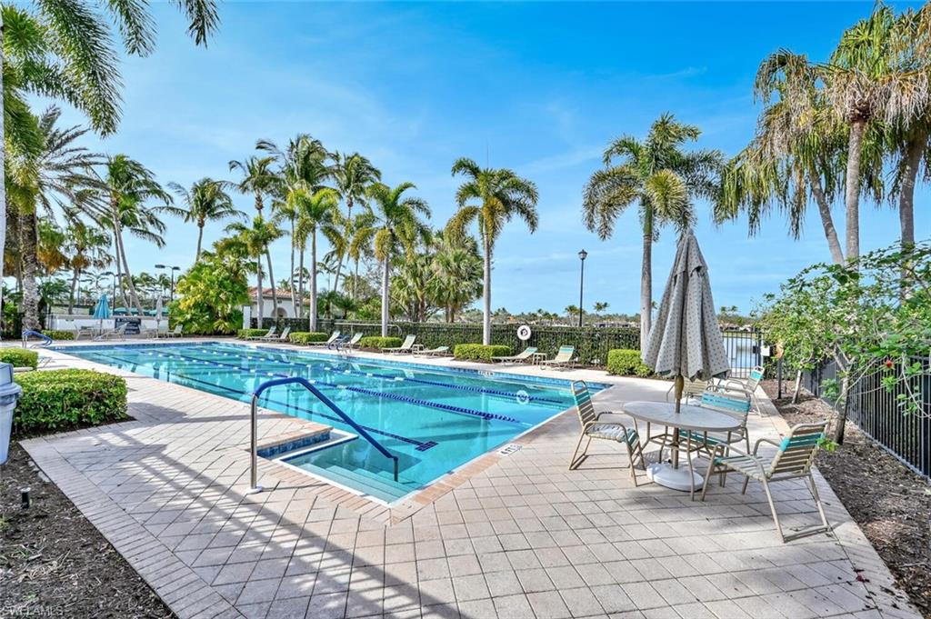 4231 Redonda Lane Naples, FL 34119 - Photo 26 of 28 a view of a swimming pool with a lounge chair and a yard