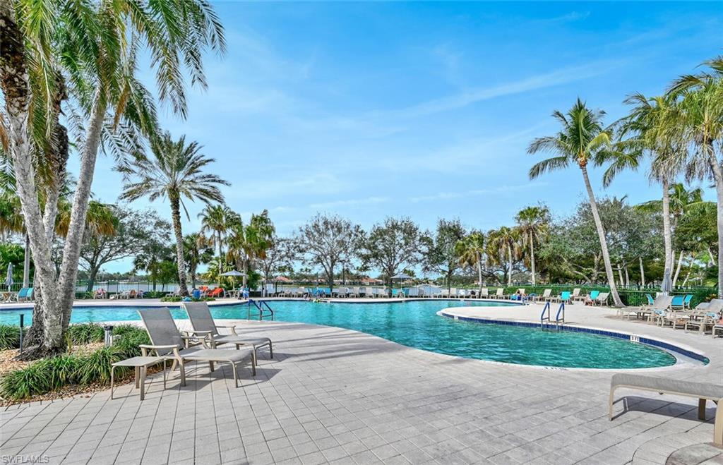 4231 Redonda Lane Naples, FL 34119 - Photo 27 of 28 a view of a swimming pool with a table and chairs