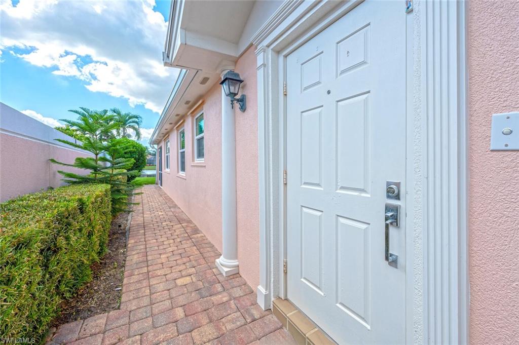 4231 Redonda Lane Naples, FL 34119 - Photo 3 of 28 a view of a pathway with a flower plants