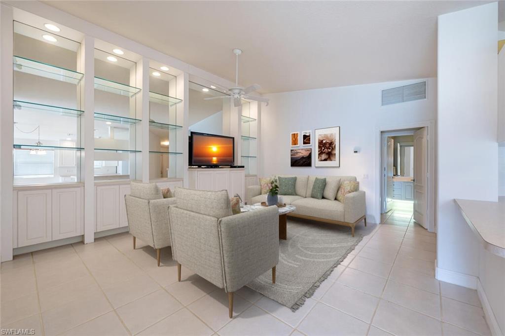 4231 Redonda Lane Naples, FL 34119 - Photo 4 of 28 a living room with furniture and a flat screen tv