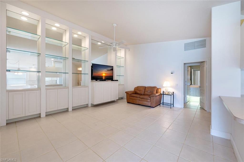 4231 Redonda Lane Naples, FL 34119 - Photo 5 of 28 a living room with furniture and a flat screen tv