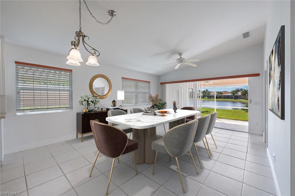4231 Redonda Lane Naples, FL 34119 - Photo 8 of 28 a view of a dining room and kitchen with a table and chairs